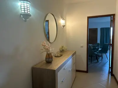 a bathroom with a vanity with a mirror and a table at Dream place- Bela Vista in Albufeira