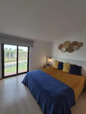 a bedroom with a large bed and a large window at Apartamento T2 86B na Praia Sao Rafael, Vista Mar - Albufeira in Albufeira