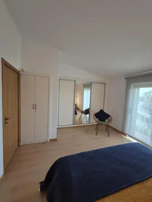 a bedroom with a bed and a large window at Apartamento T2 86B na Praia Sao Rafael, Vista Mar - Albufeira in Albufeira
