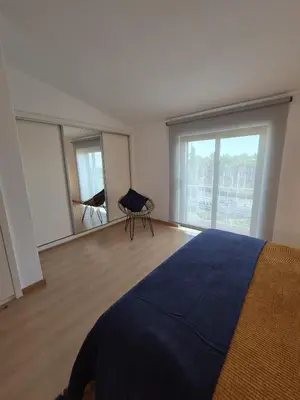 a bedroom with a bed and a large window at Apartamento T2 86B na Praia Sao Rafael, Vista Mar - Albufeira in Albufeira
