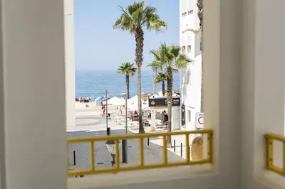 a view of the beach from a window at Flores 2Bedroom Apartment - Sea view Quarteira in Quarteira
