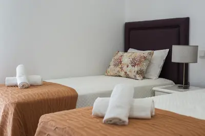 a hotel room with two beds with towels at Flores 2Bedroom Apartment - Sea view Quarteira in Quarteira
