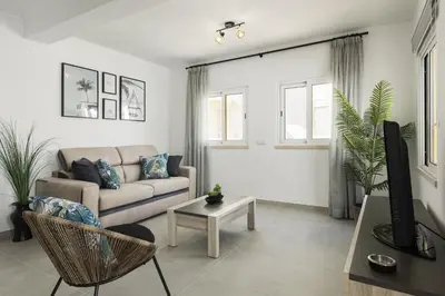 a living room with a couch and a table at Flores 2Bedroom Apartment - Sea view Quarteira in Quarteira