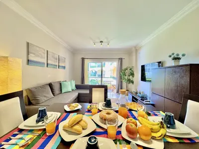 a living room with a table with food on it at Vilamoura Beach Village 1 With Pool by Homing in Vilamoura