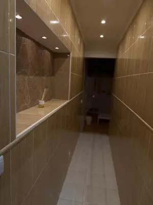 a hallway of a bathroom with a toilet at Faro Coast Guest House in Faro