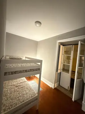 a bedroom with two bunk beds and a doorway at Faro Coast Guest House in Faro