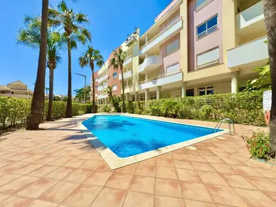 a swimming pool in front of a building at Vilamoura Lovely Beach Stay With Pool by Homing in Vilamoura