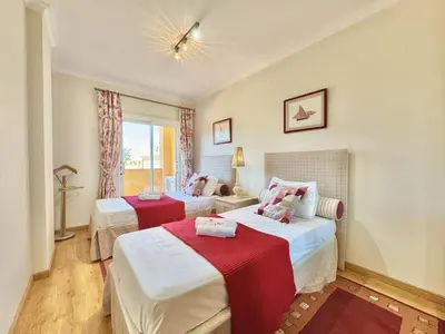 a bedroom with two beds with red and white sheets at Vilamoura Lovely Beach Stay With Pool by Homing in Vilamoura