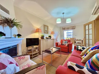 a living room with red furniture and a fireplace at Vilamoura Lovely Beach Stay With Pool by Homing in Vilamoura