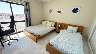 a bedroom with two beds and a window at Cozy Sea View in Albufeira