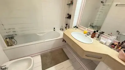 a bathroom with two sinks and a bath tub at Cozy Sea View in Albufeira