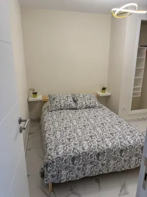 a bedroom with a bed in a white room at Excelente férias in Albufeira