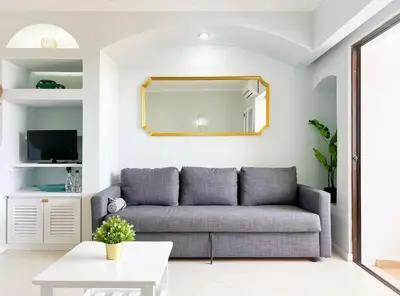 a living room with a couch and a mirror at Sea View Apartment Albufeira in Albufeira