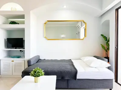 a bedroom with a bed and a mirror on the wall at Sea View Apartment Albufeira in Albufeira