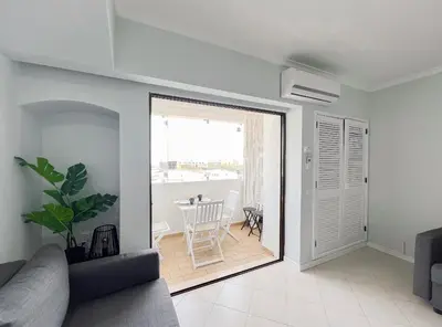 a living room with a couch and a table at Sea View Apartment Albufeira in Albufeira