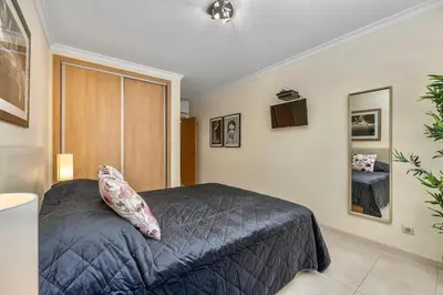 a bedroom with a bed with a pillow on it at Pool with Beach 10' Away - Comfort and Tranquility in Quarteira