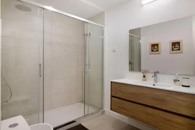a bathroom with a shower and a sink at Beautiful 2 Bedroom Self Catering Apartment with Private Pool and Garden in the Encosta do Lago Resort in Quinta do Lago in Quinta do Lago