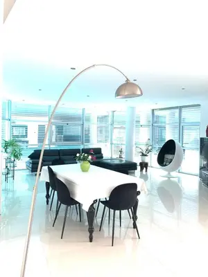 a living room with a white table and black chairs at Vila orada lola in Albufeira