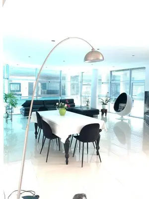 a living room with a white table and black chairs at Vila orada lola in Albufeira