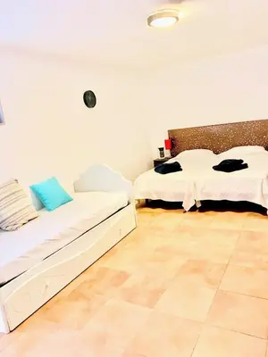 a room with two beds and a tiled floor at Vila orada lola in Albufeira