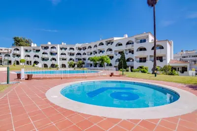 a swimming pool in front of a large building at Valmangude - Collection design par Enjoyyourstay in Albufeira