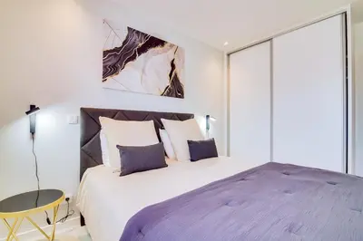 a bedroom with a large bed and a table at Valmangude - Collection design par Enjoyyourstay in Albufeira