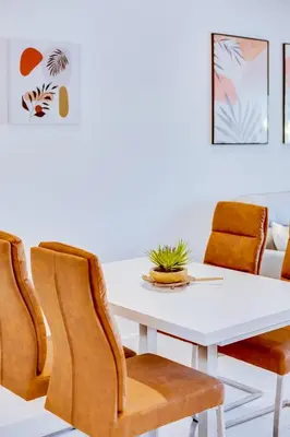 a dining room with a white table and chairs at Valmangude - Collection design par Enjoyyourstay in Albufeira