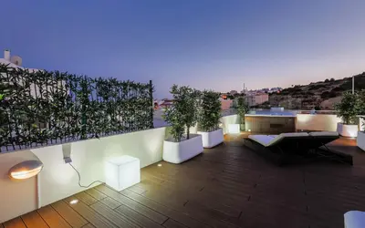 a rooftop patio with potted plants on a building at D_Loft Downtown in Albufeira