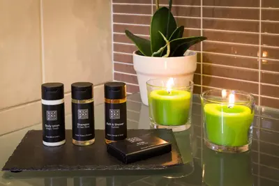 a table with two candles and green candles at D_Loft Downtown in Albufeira