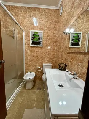 a bathroom with a sink and a toilet and a shower at OldTownPool Albufeira in Albufeira