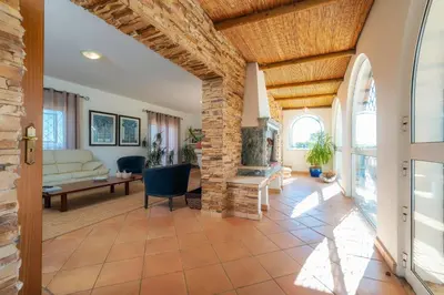 a living room with a couch and a table at Villa 4 Quartos, Piscina, BBQ Snooker, Prestige For Home in Quarteira