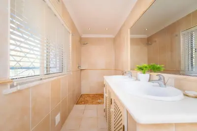 a bathroom with two sinks and a window at Villa 4 Quartos, Piscina, BBQ Snooker, Prestige For Home in Quarteira