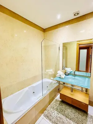 a bathroom with a tub and a sink at Albufeira Comfort Luxury Quinta Barracuda in Albufeira
