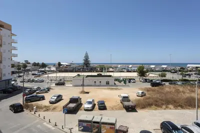 a parking lot with cars parked in a parking lot at Espadarte - Sea view by HD in Quarteira