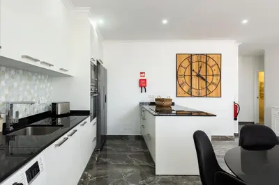 a kitchen with a sink and a counter top at Espadarte - Sea view by HD in Quarteira