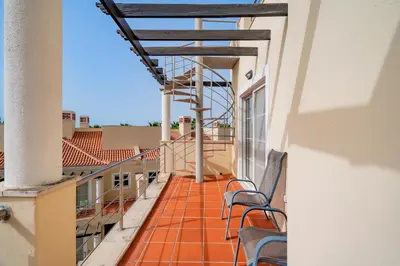 a balcony of a building with chairs on it at Palmyra Apartments in Vilamoura in Vilamoura