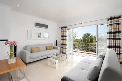 a living room with a couch and a table at Palmyra Apartments in Vilamoura in Vilamoura