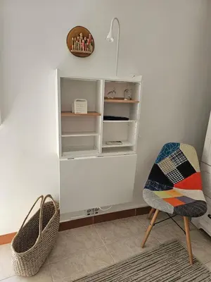 a room with a book shelf and a chair at Faro Heart House in Faro