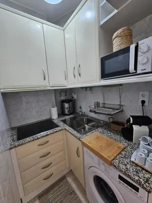 a kitchen with a sink and a washing machine at Faro Heart House in Faro