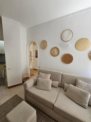 a living room with a couch and mirrors on the wall at Faro Heart House in Faro