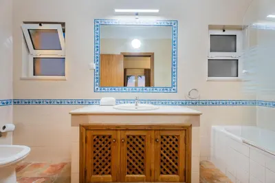 a bathroom with a sink and a mirror at Villa Las Rosas in Albufeira