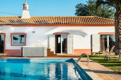 a villa with a swimming pool in front of a house at Villa Las Rosas in Albufeira