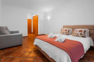 a bedroom with a large bed with towels on it at Villa Las Rosas in Albufeira