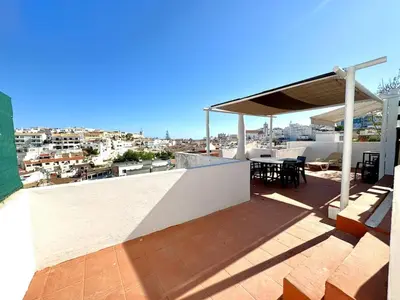 a balcony with a table and a view of a city at Villa Terraza - Center Hideaway in Albufeira