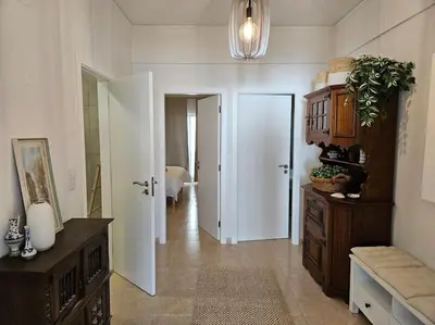 a room with a hallway with two doors and a room with a bedroom at Apartamento moderno na praia com varanda grande in Quarteira