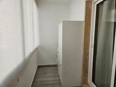 a hallway with a white refrigerator in a room at Apartamento moderno na praia com varanda grande in Quarteira