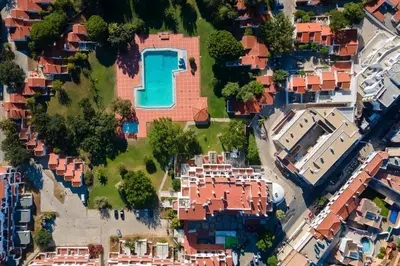 an aerial view of a house with a swimming pool at Albufeira Oura Apartment in Albufeira