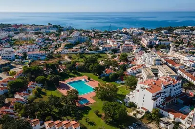 an aerial view of a city with a swimming pool at Albufeira Oura Apartment in Albufeira