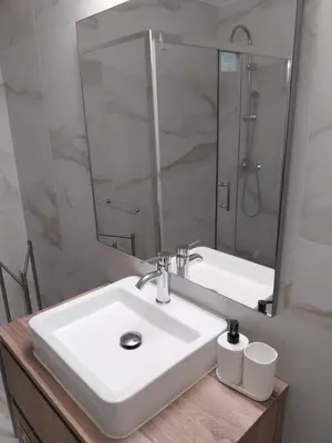 a bathroom with a sink and a mirror at Albufeira Oura Apartment in Albufeira