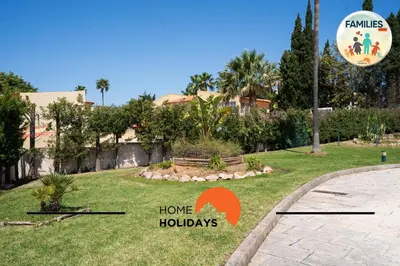 a park with a sign that says home holidays at #275 Only Families - A Flor by Home Holidays in Albufeira